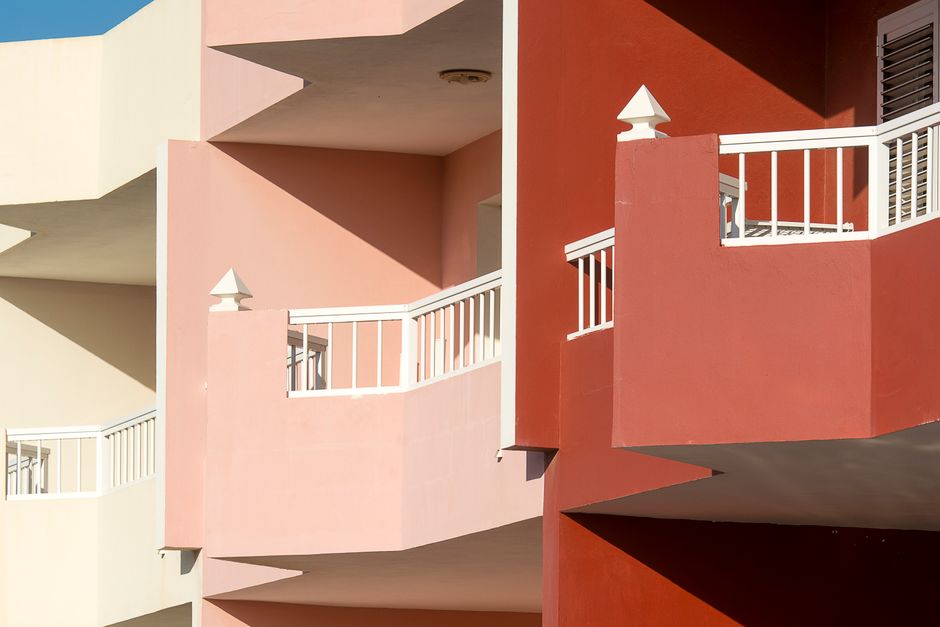 Painted apartment balconies in several colors.