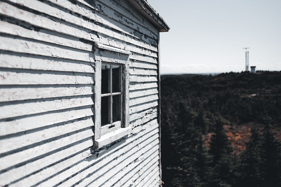 Old wooden house with peeling paint.